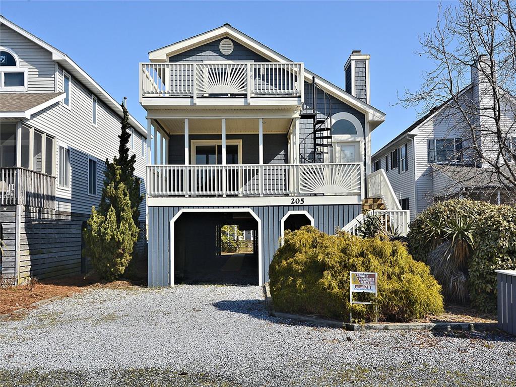 image Stunning exterior showcasing the home’s charming beach-style architecture, with plenty of parking and a welcoming entrance.