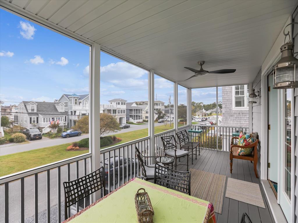 image The screened porch provides a breezy retreat with comfortable seating and stunning ocean views.