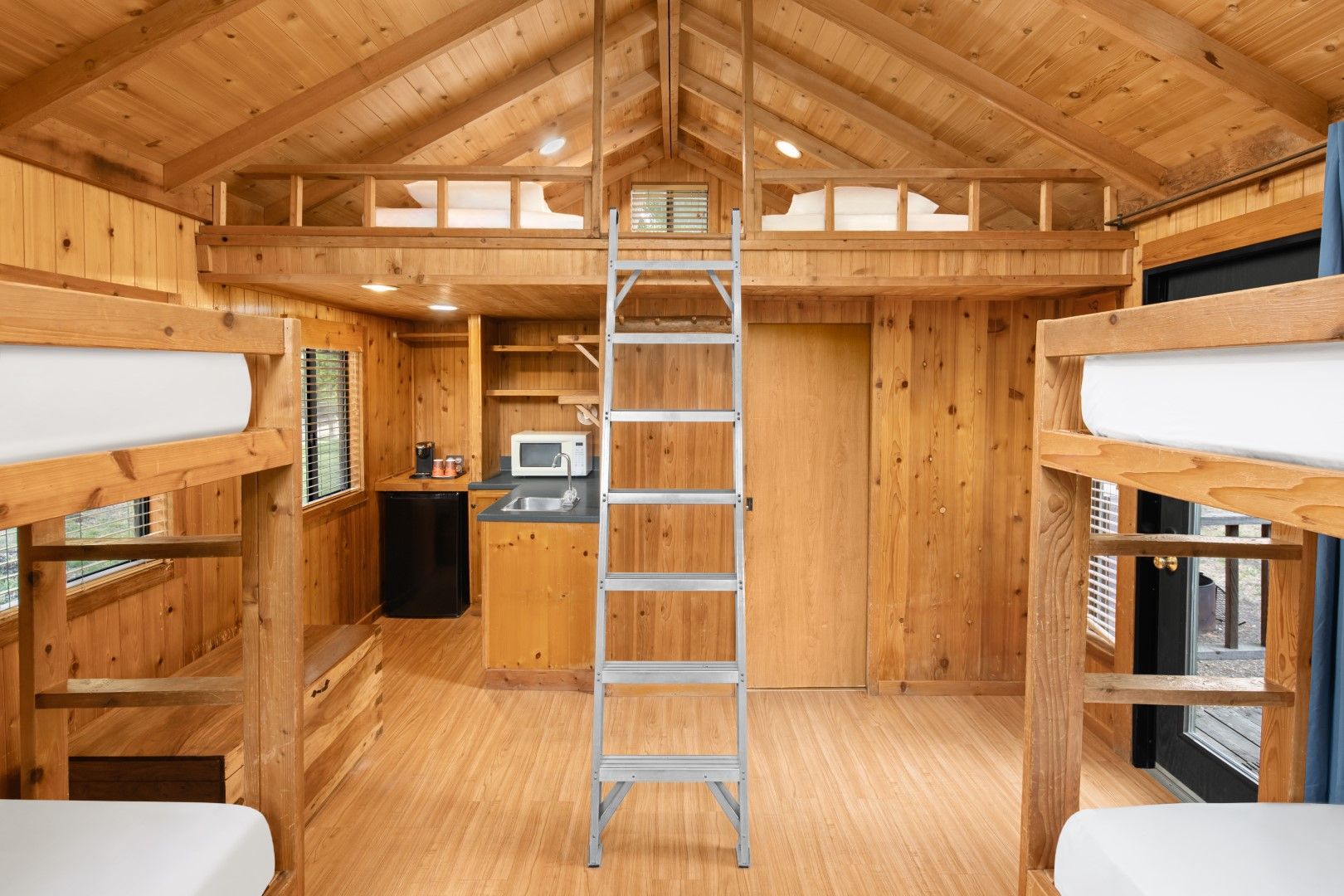 image Experience the ultimate group getaway in a multi-level cabin, featuring bunk beds, an open loft, and a welcoming atmosphere.
