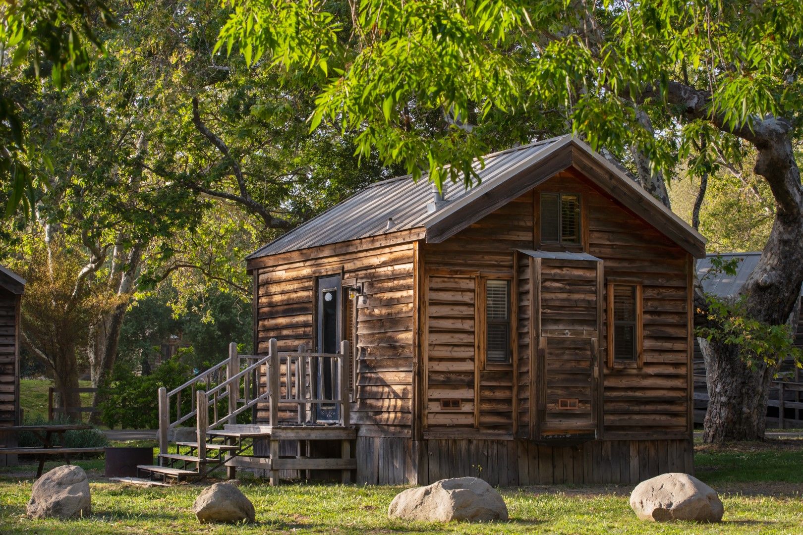 image Escape to a cozy log cabin surrounded by lush greenery, where rustic charm meets the serenity of nature.