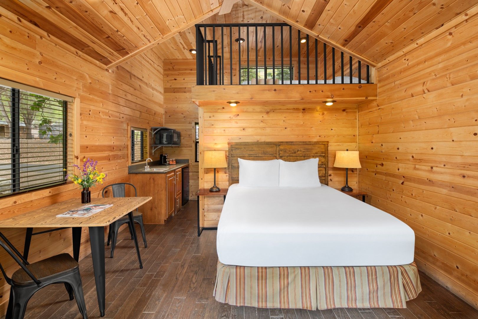 image Relax in a beautifully designed interior featuring warm wood tones, a lofted ceiling, and plenty of natural light.