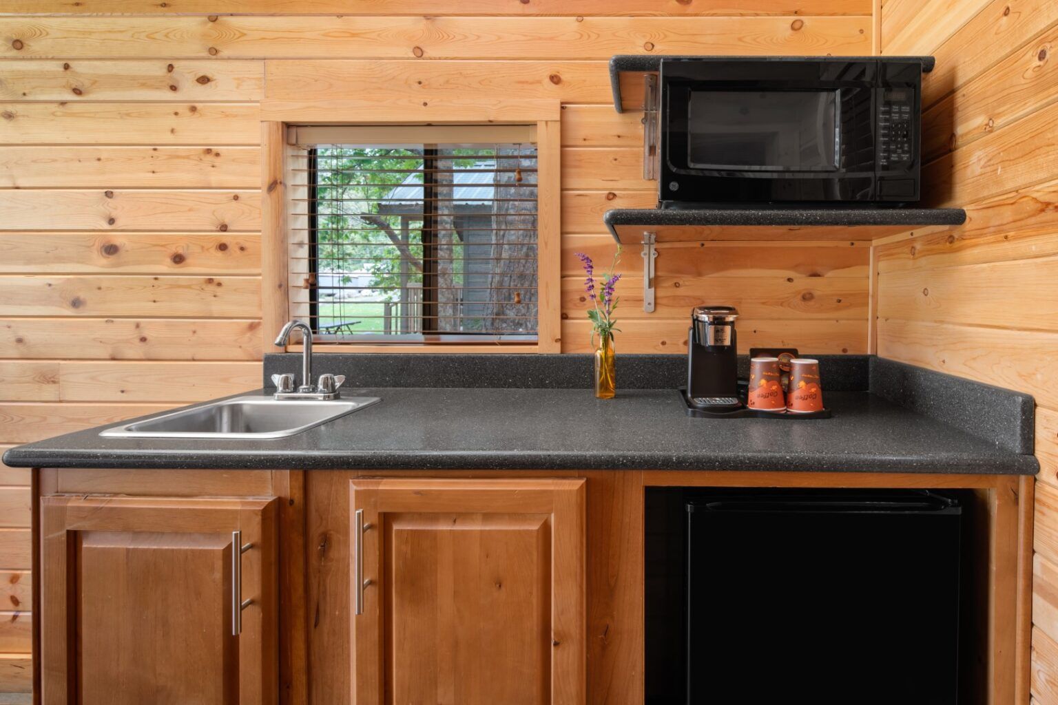 image Prepare simple meals with ease in a well-equipped kitchenette, blending convenience with the charm of cabin living.