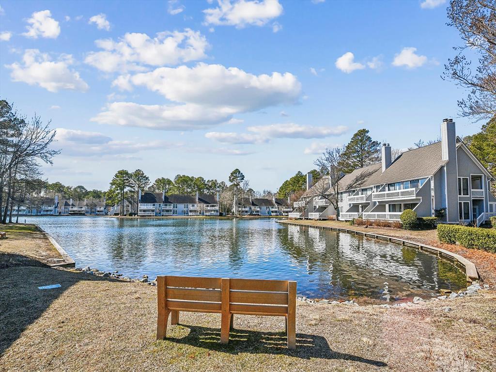 image Enjoy picturesque views of the nearby lake from a peaceful bench, perfect for contemplation or relaxation amid the serene landscape of the community.