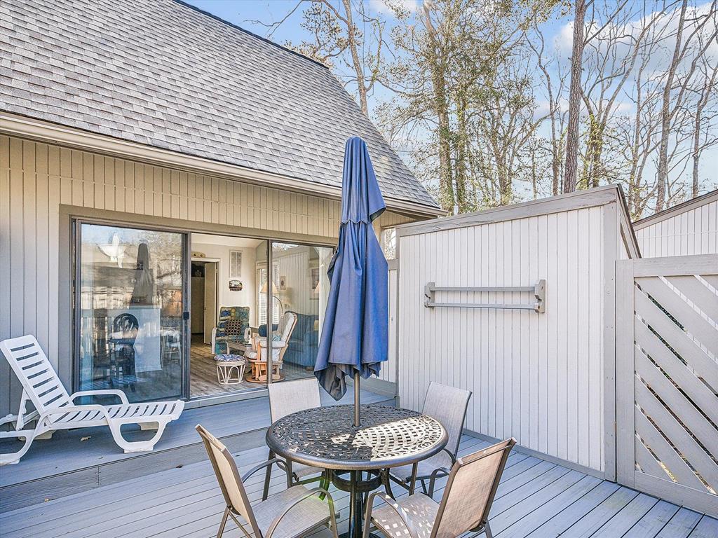 image The spacious outdoor deck, complete with a dining table and sun loungers, provides a perfect retreat for relaxation surrounded by nature.
