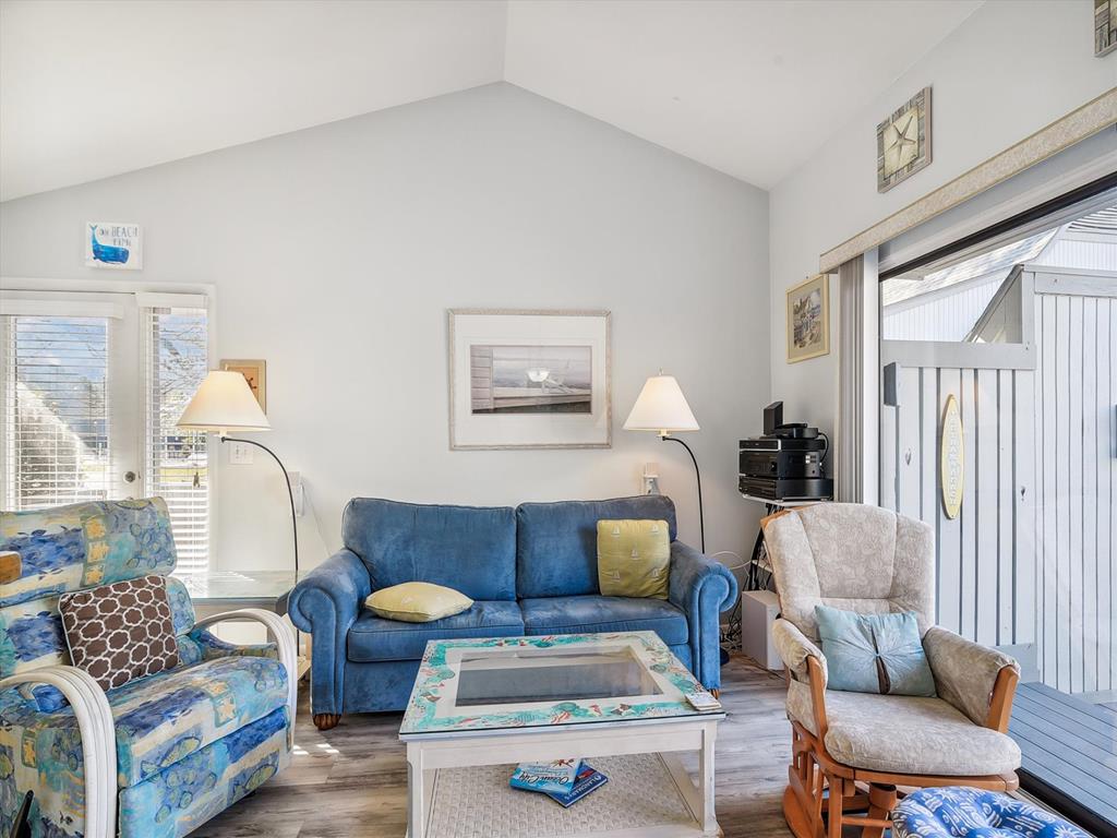 image The comfortable living room area is adorned with a mix of colorful furniture, big windows, and a casual ambiance perfect for unwinding.