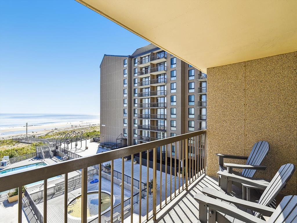 image Private balcony with seating and panoramic views of the ocean and surrounding towers.