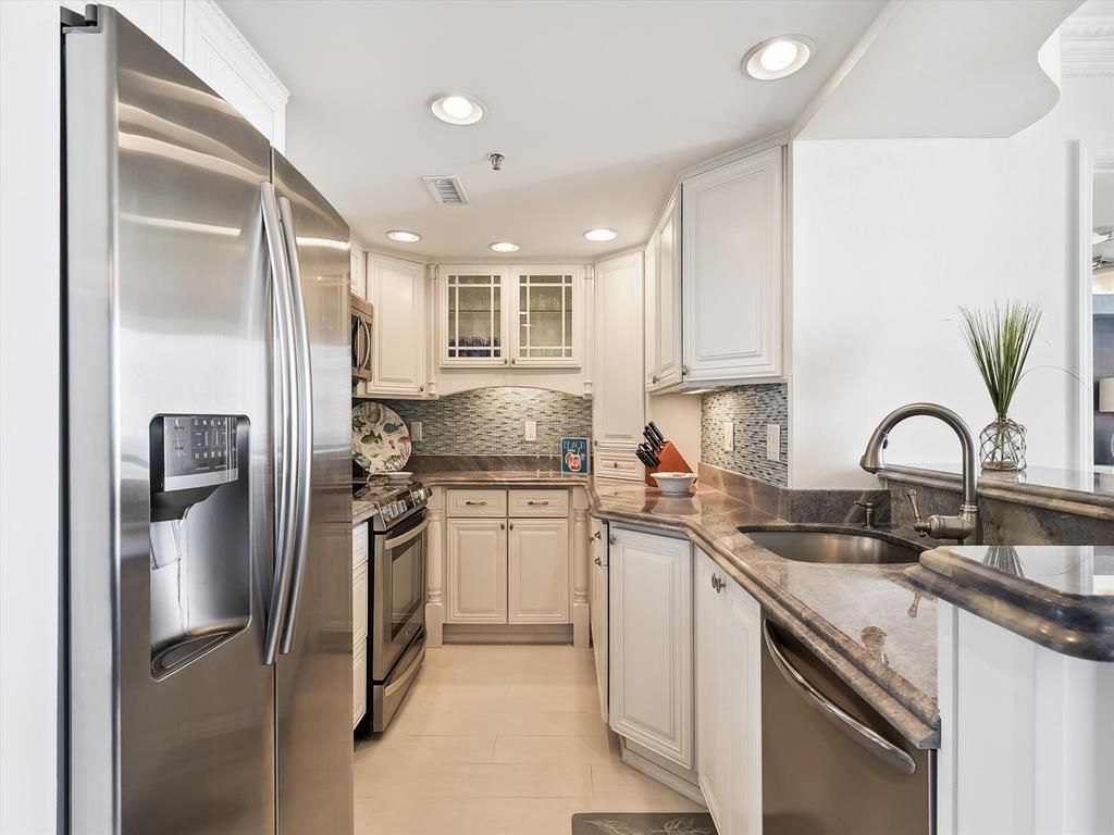 image The spacious kitchen features high-end stainless steel appliances and elegant hand-painted ceramic accents, creating a perfect blend of style and functionality for culinary enthusiasts.