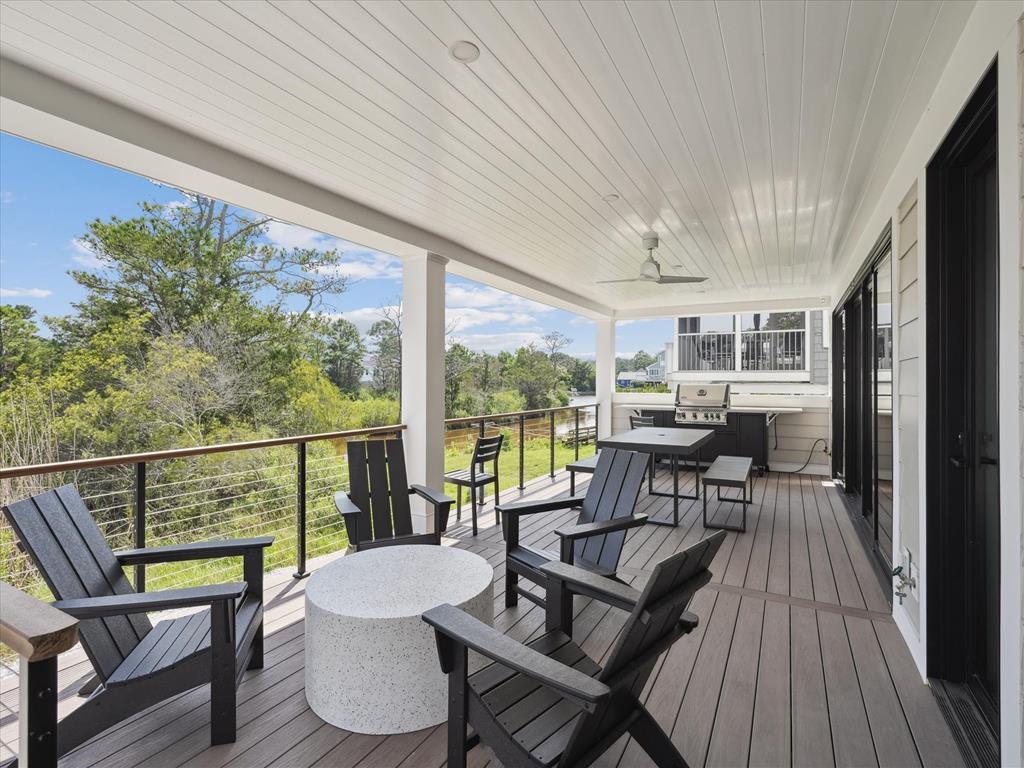 image The spacious outdoor deck features comfortable seating and a grilling area, perfect for enjoying the serene surroundings.