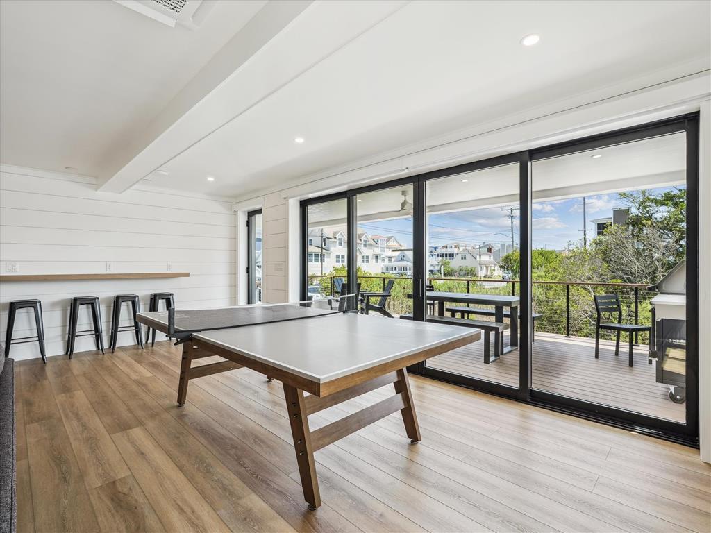 image This light-filled area boasts a ping pong table and creative workspace, blending relaxation with recreational activities just steps from the beach.