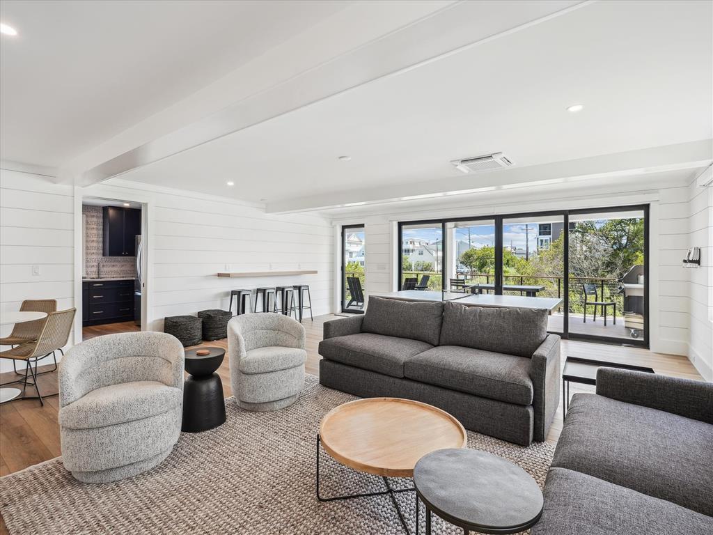 image An inviting living space showcases plush seating and seamless access to outdoor decks, perfect for relaxation and entertainment.