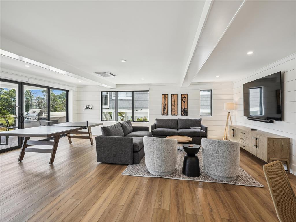 image Spacious living room featuring large windows that flood the area with natural light and a perfect spot for relaxation.