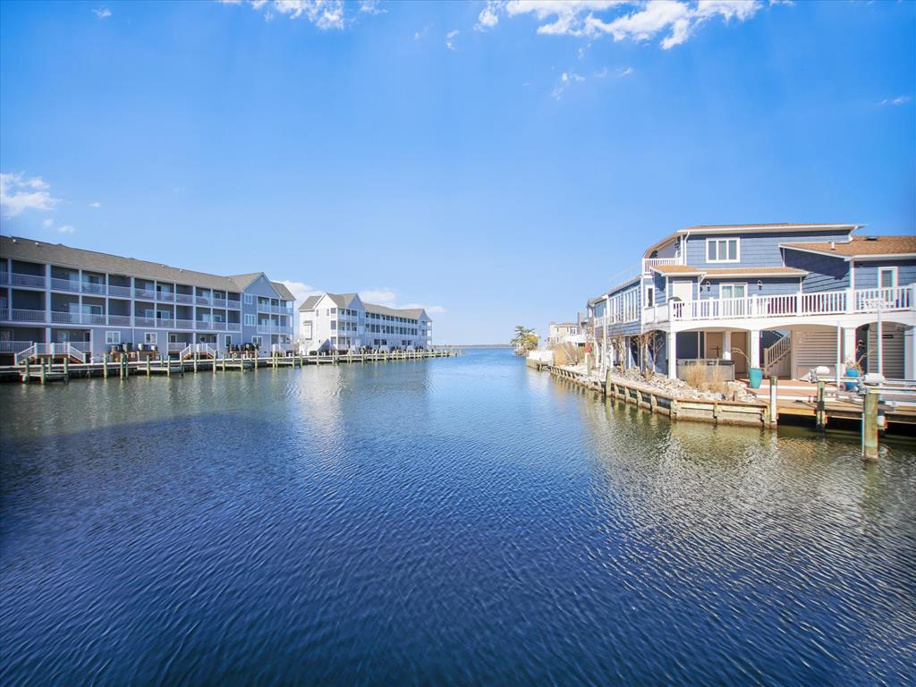 image Experience serene waterfront living with stunning views from your property situated along a tranquil canal.