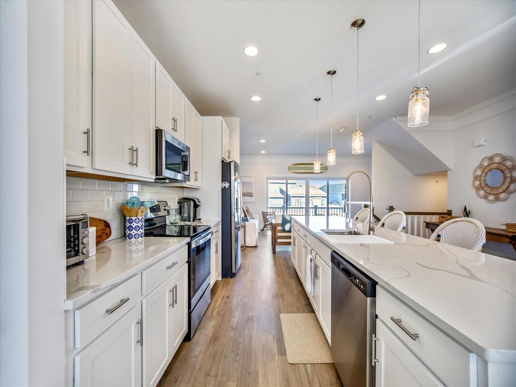 image Experience culinary bliss in a modern kitchen featuring sleek countertops, stainless steel appliances, and an open layout perfect for family gatherings.