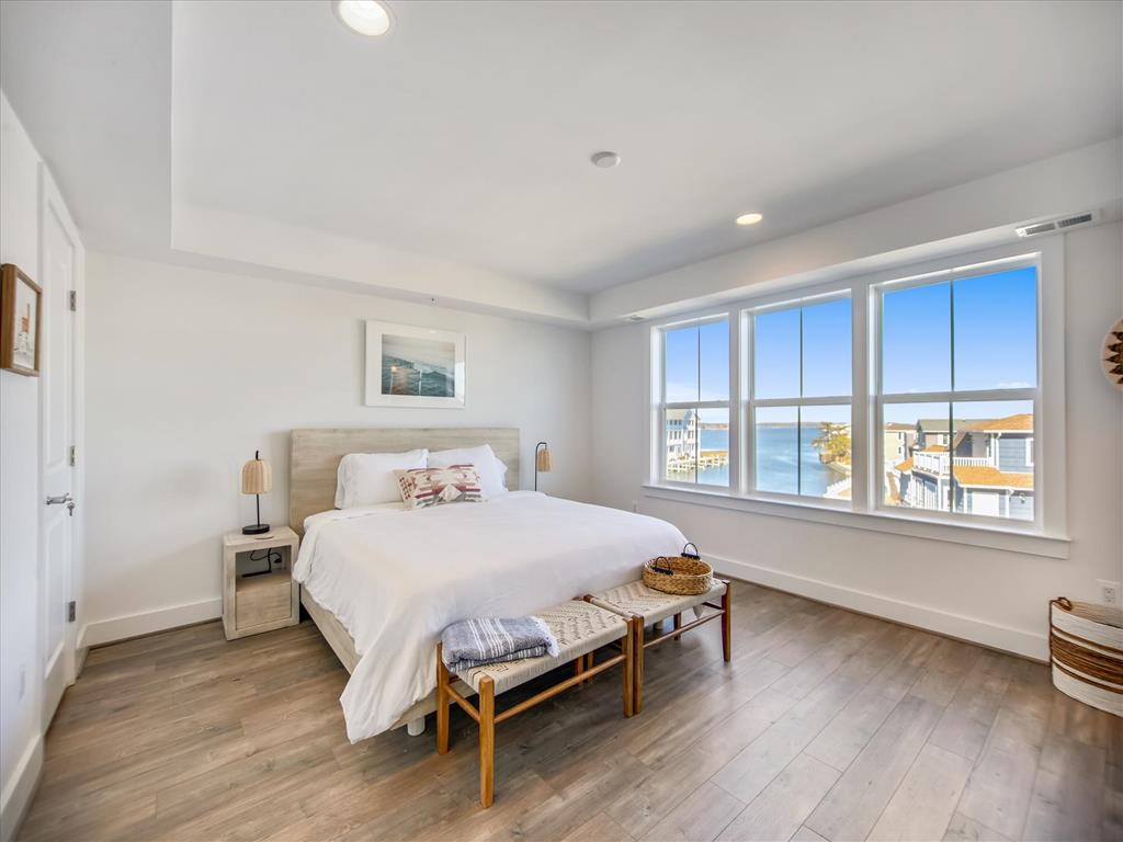 image Revel in stunning waterfront views from this charming bedroom, which provides an ideal setting for unwinding after a beach day.