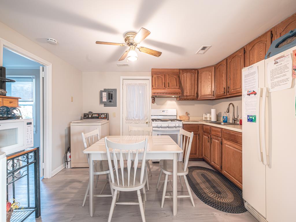 image The cozy kitchen features new flooring and a welcoming dining area, making meal prep a breeze.