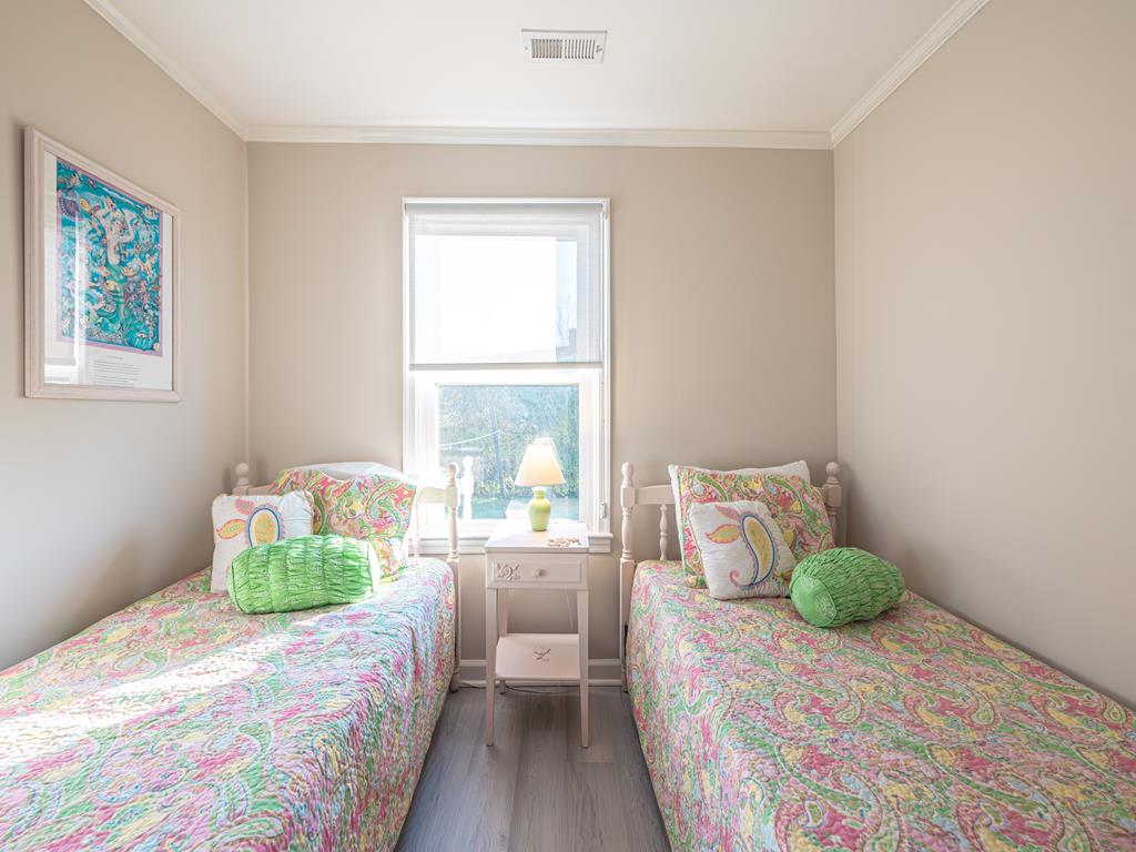 image Bathed in natural light, this charming twin bedroom is a peaceful retreat with soft coastal tones.