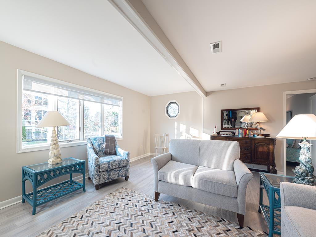 image The beautifully arranged living space offers a bright and airy feel, perfect for relaxation after a day at the beach.