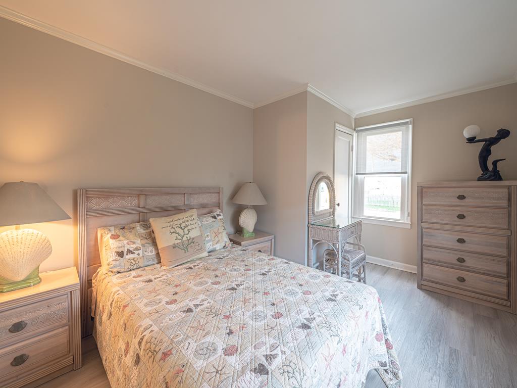 image Inviting bedroom featuring elegant decor, a comfortable double bed, and plenty of natural light.