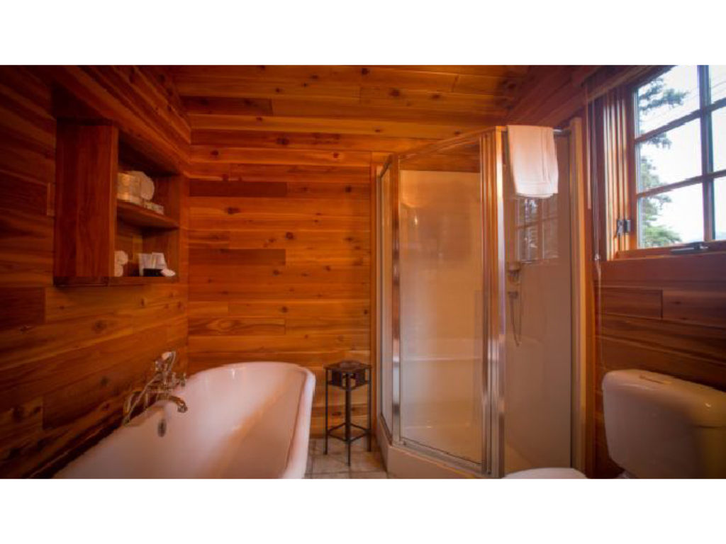 image A beautifully crafted bathroom with natural wood accents offers a tranquil space to refresh and unwind.