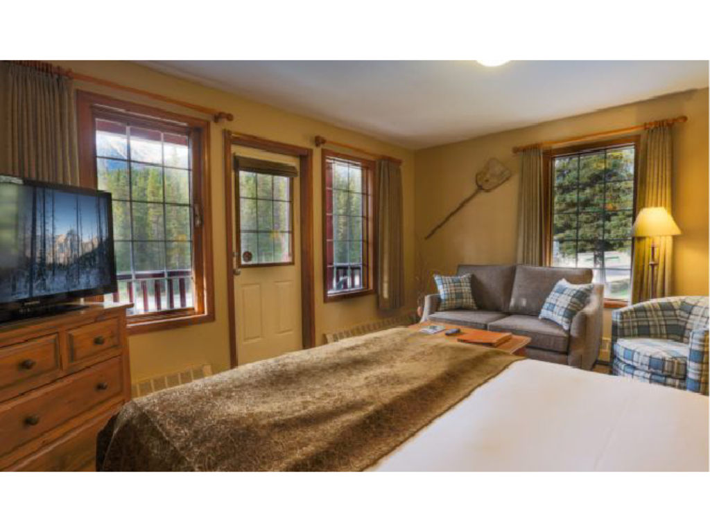 image Large windows invite natural light and breathtaking views, making this cozy space feel bright and welcoming.