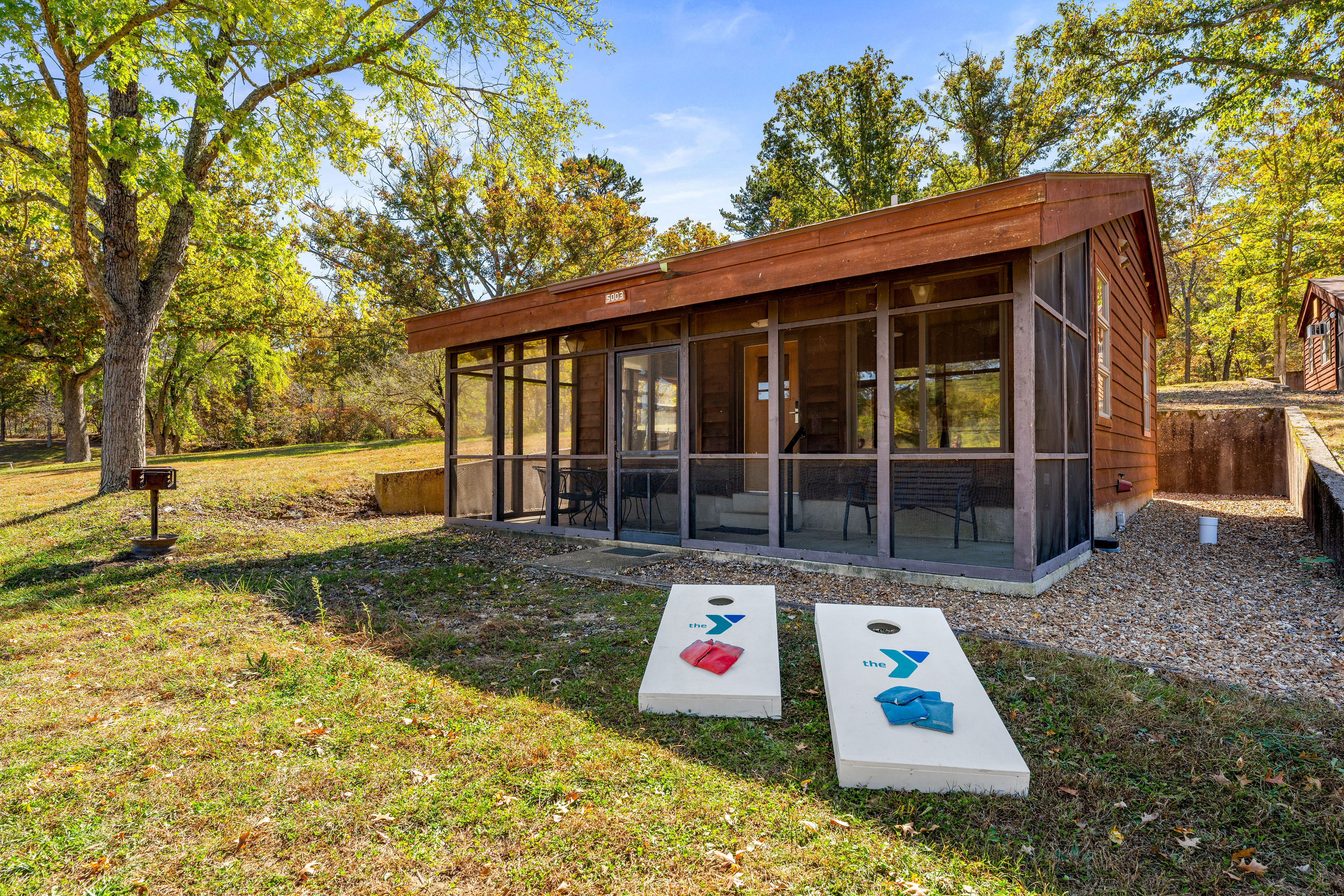 image Enjoy outdoor fun with cornhole boards set up just outside the cabin.