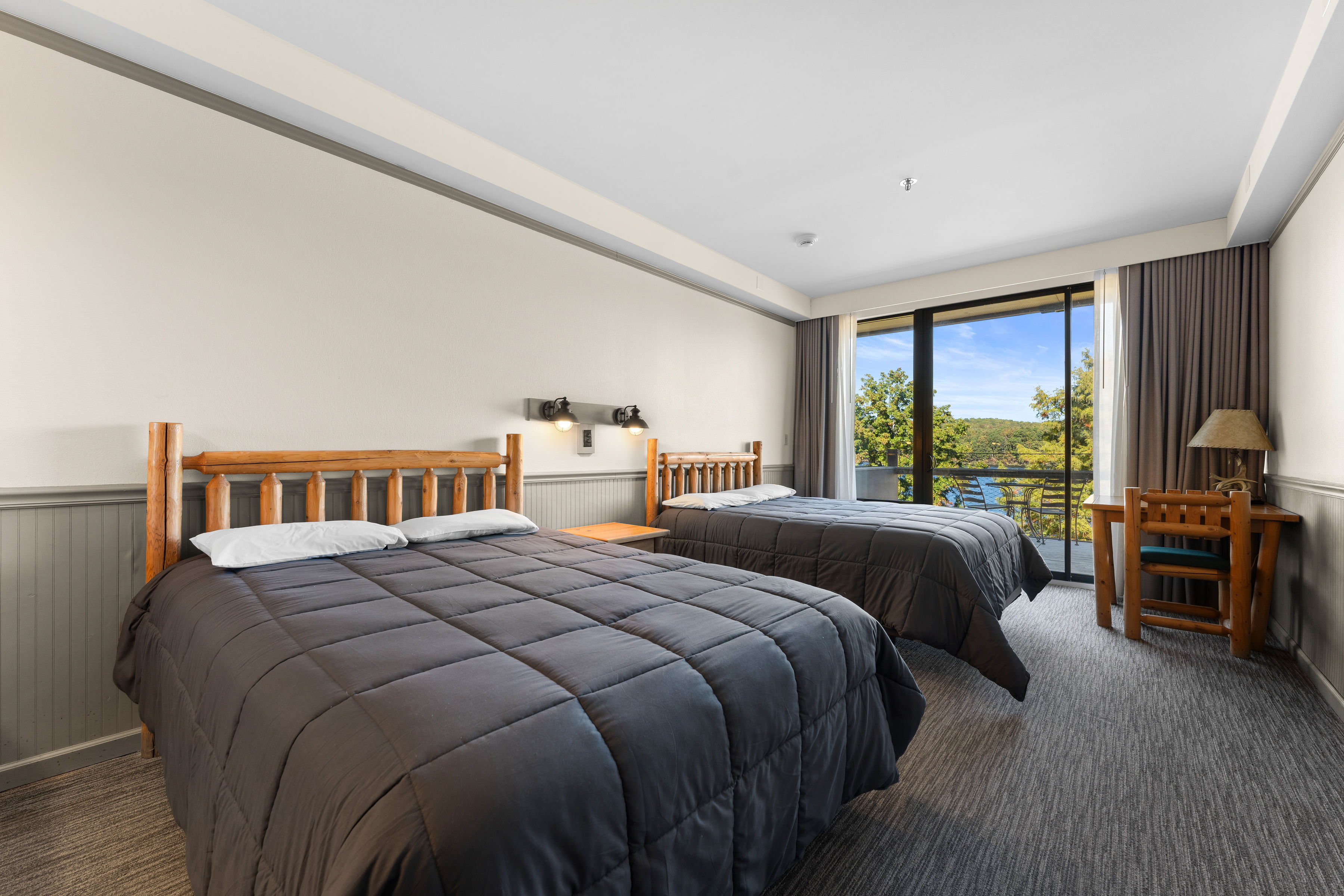 image Cozy double queen room with a lake view, perfect for a relaxing retreat after a day of outdoor adventures.