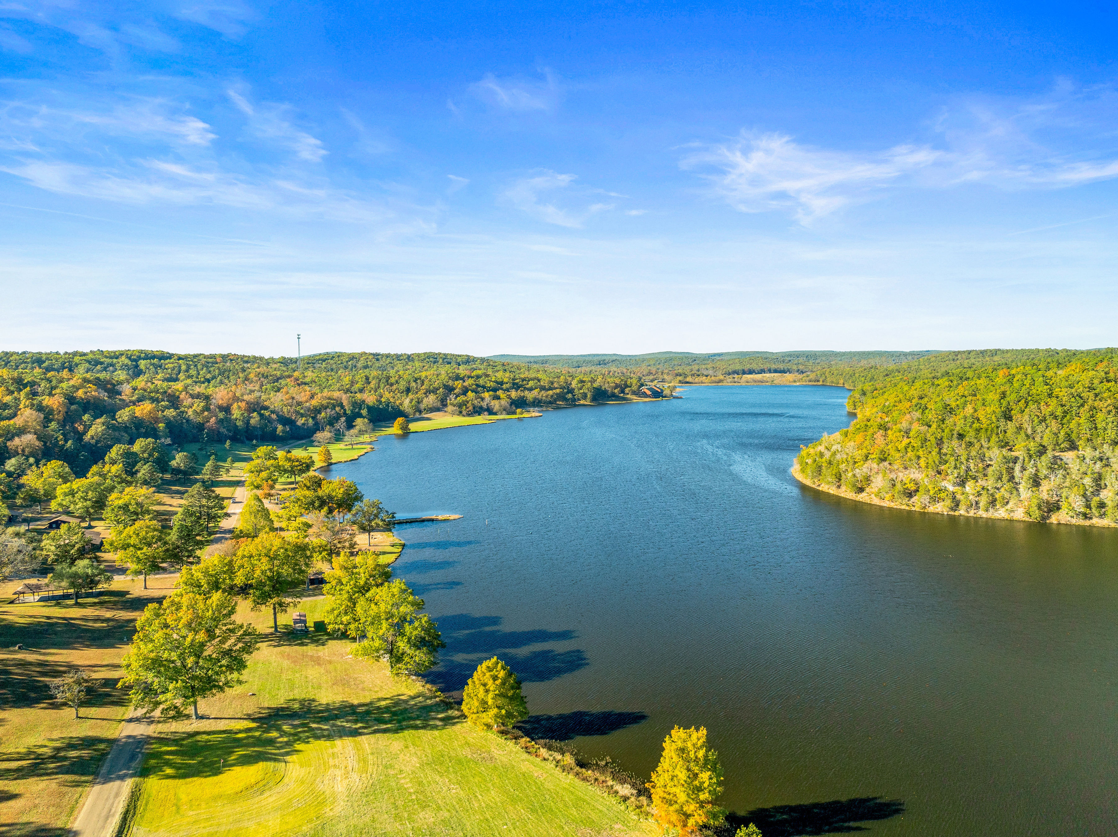 image Aerial views showcasing the serene beauty of Sunnen Lake, surrounded by lush rolling hills and nature trails.