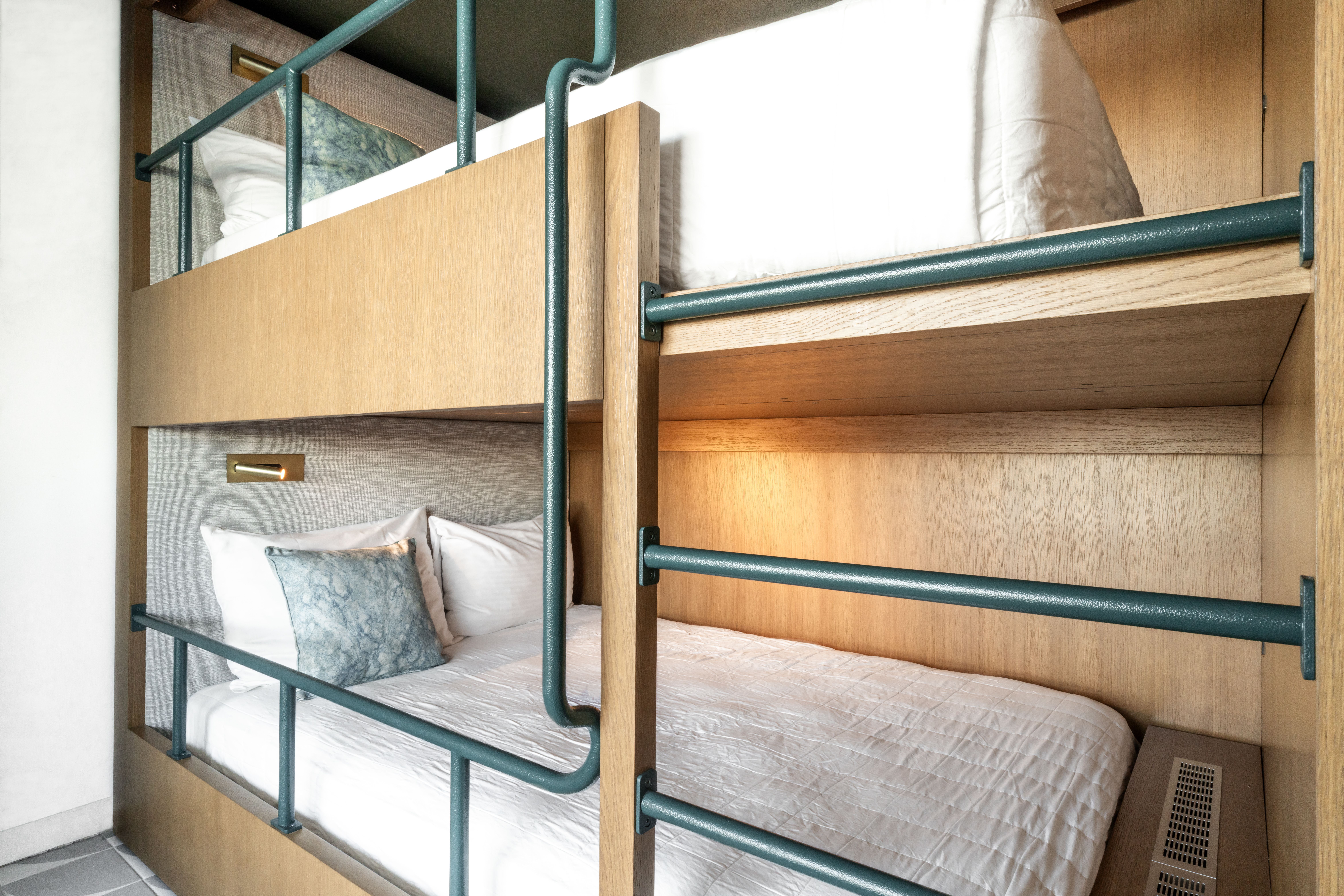 image A cozy nest for kids or friends, these bunks invite late-night whispers and restful sleeps after long days in the sun.