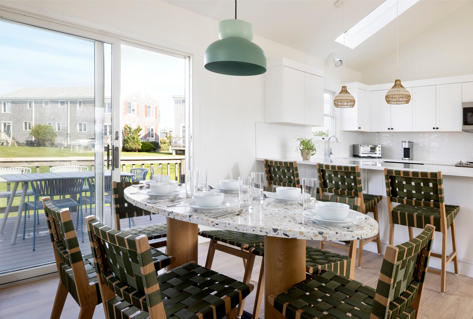 image Share stories and seaside flavors around a sunlit table that opens to the breeze beyond.
