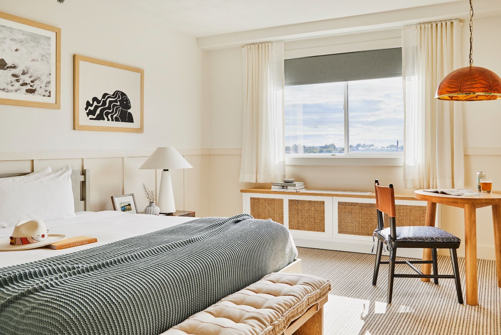 image Experience a cozy atmosphere in the King Room Accessible, featuring a plush king bed and a stylish workspace beside a window that invites natural light.