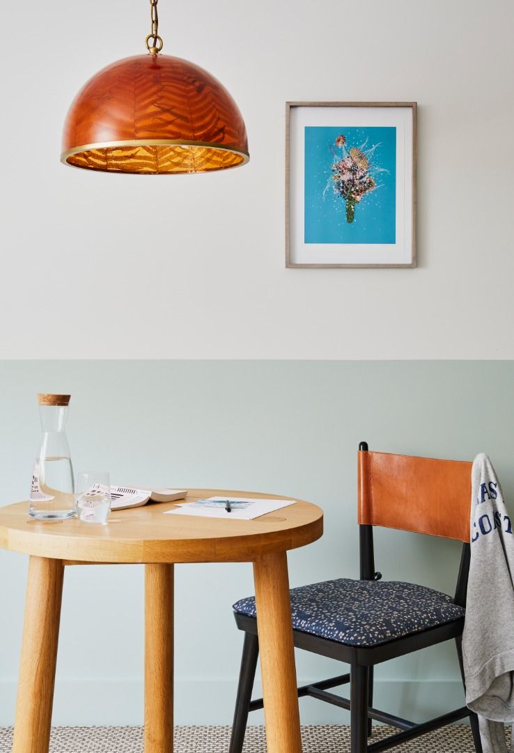 image Enjoy the cozy seating area illuminated by a stylish pendant light, perfect for relaxation or planning your day.