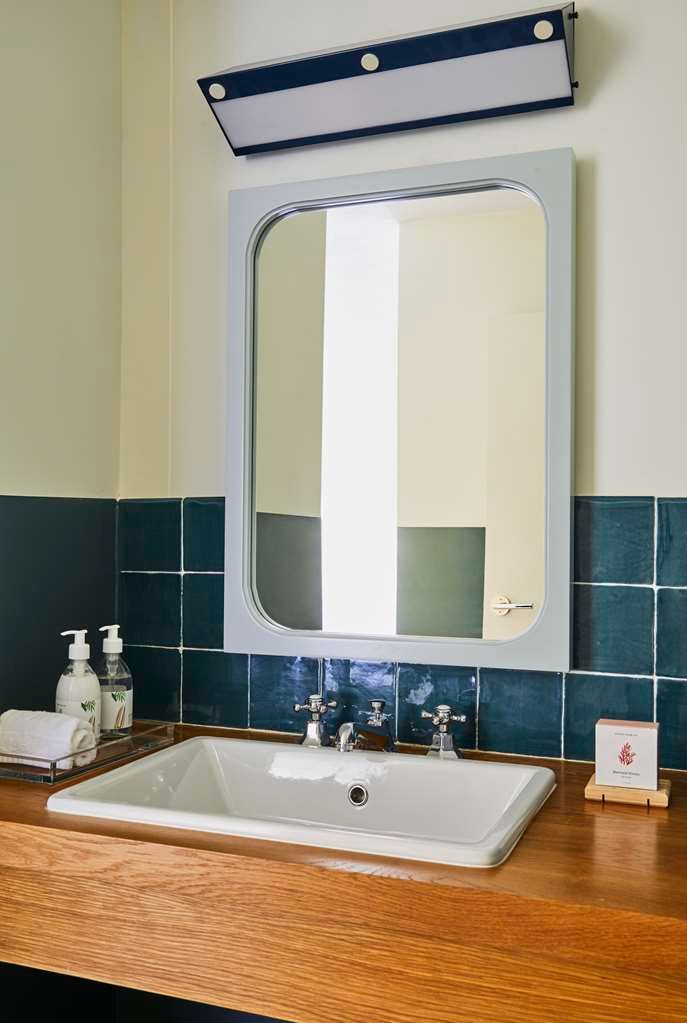 image The ADA-accessible bathroom features a sleek sink area with contemporary fixtures and elegant finishes.