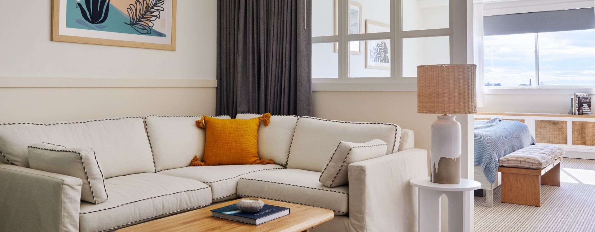 image Relax in the inviting living space, highlighted by natural light and thoughtfully designed decor, creating a warm and welcoming ambiance.