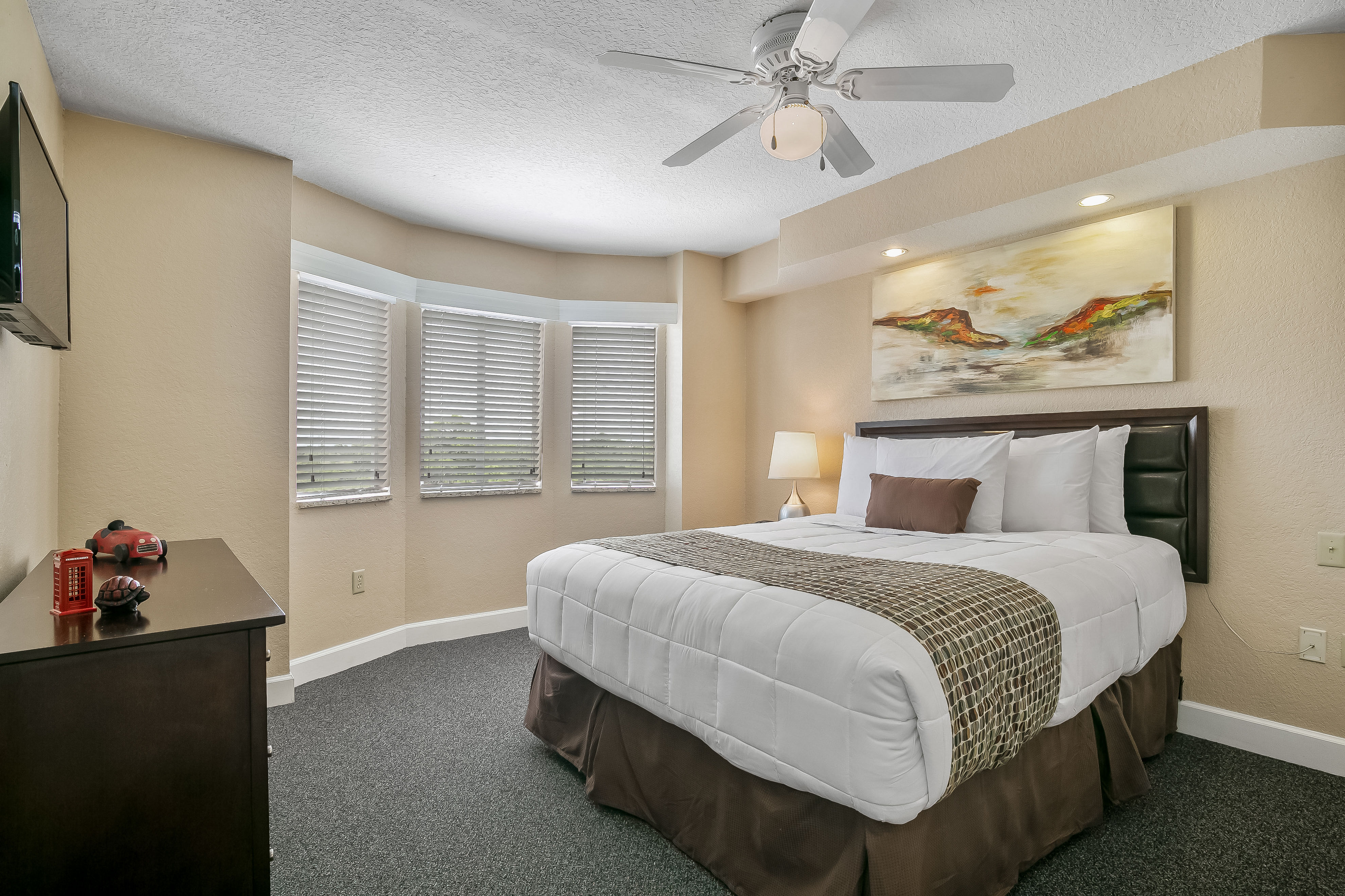 image The serene bedroom provides a plush king-size bed, charming artwork, and ample natural light flowing in through the stylish bay windows.