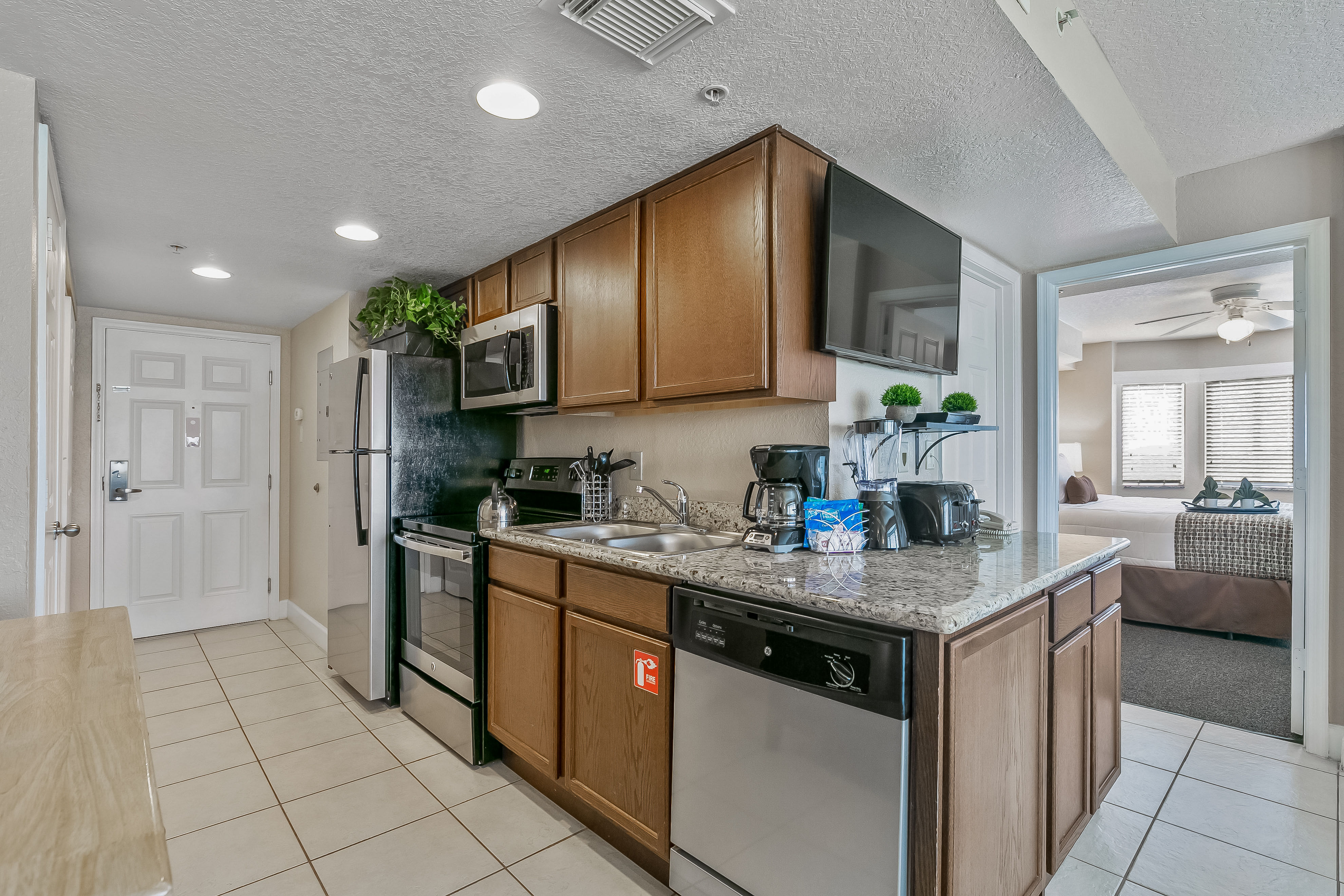 image The modern kitchen is equipped with stainless steel appliances, granite countertops, and essential kitchenware, making meal preparation enjoyable and effortless.