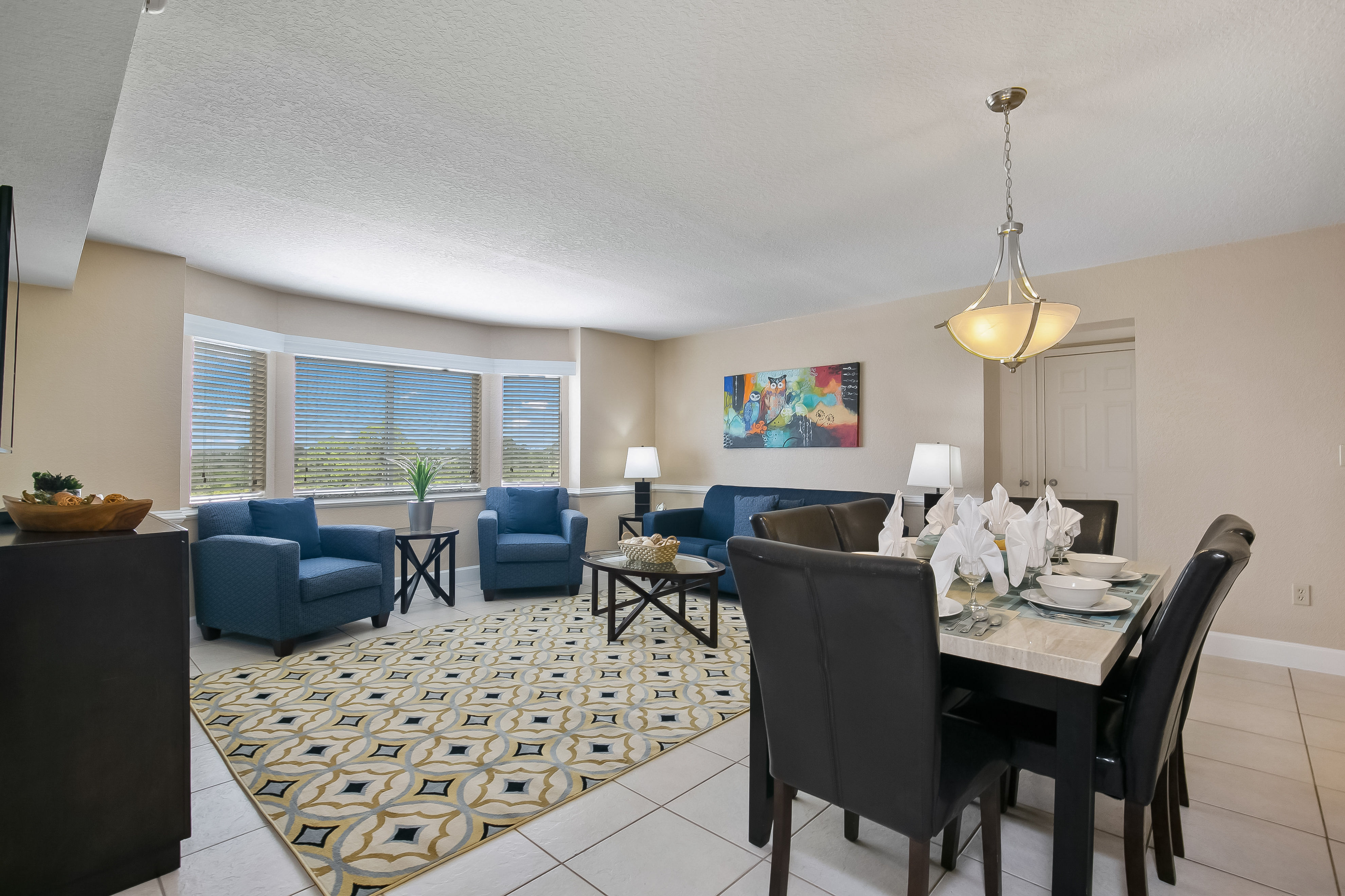 image Experience dining and relaxation in an open living and dining area, complete with tasteful decor, a fully equipped kitchen, and a comfortable seating arrangement.