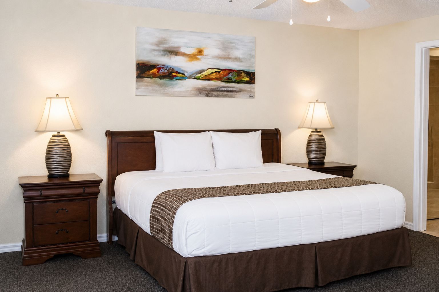 image Rest in style within this inviting bedroom featuring a comfortable king-size bed, perfect for a restful night’s sleep after a day of activities.
