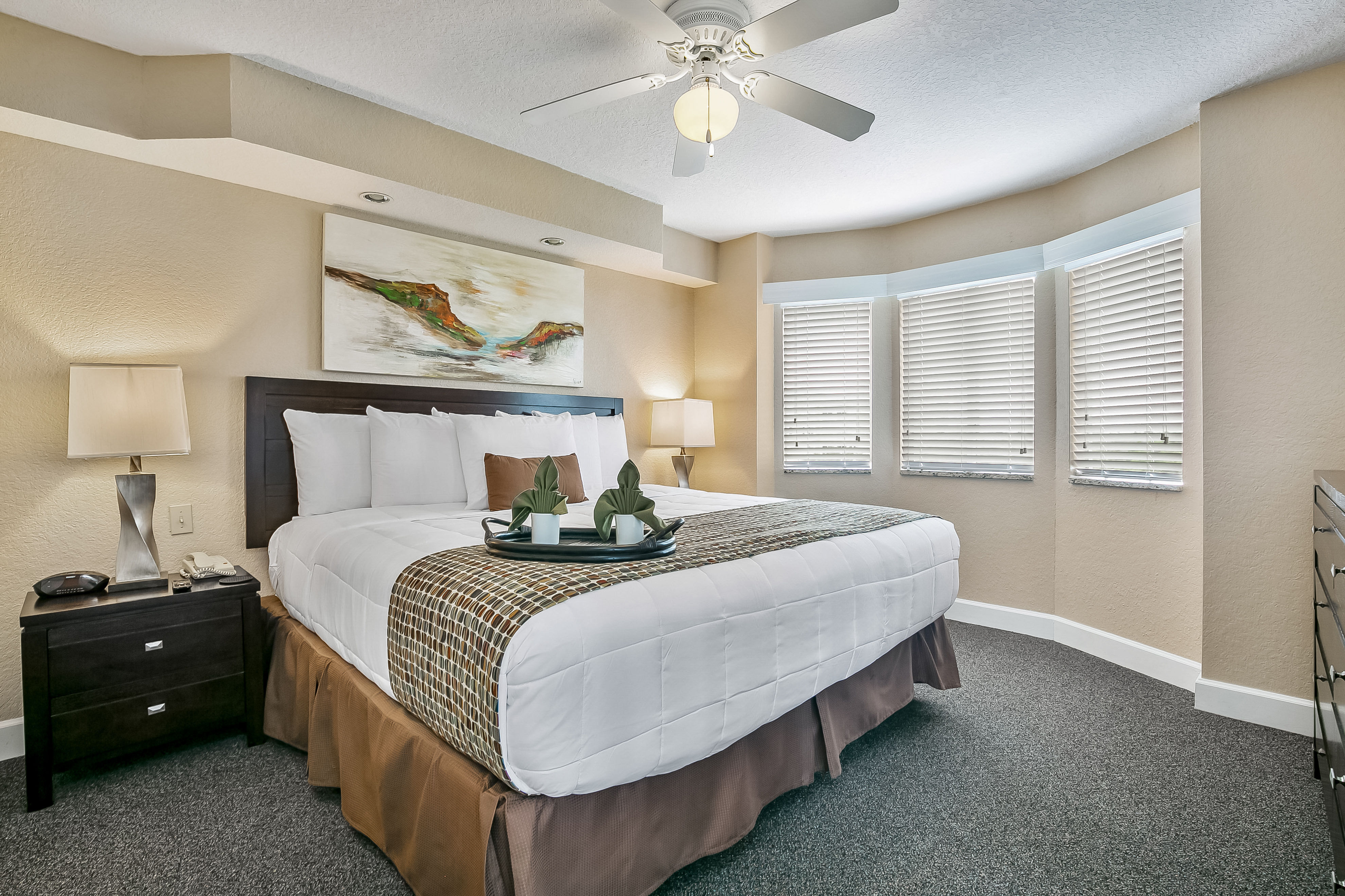 image Rest in style within this inviting bedroom featuring a comfortable king-size bed, perfect for a restful night’s sleep after a day of activities.