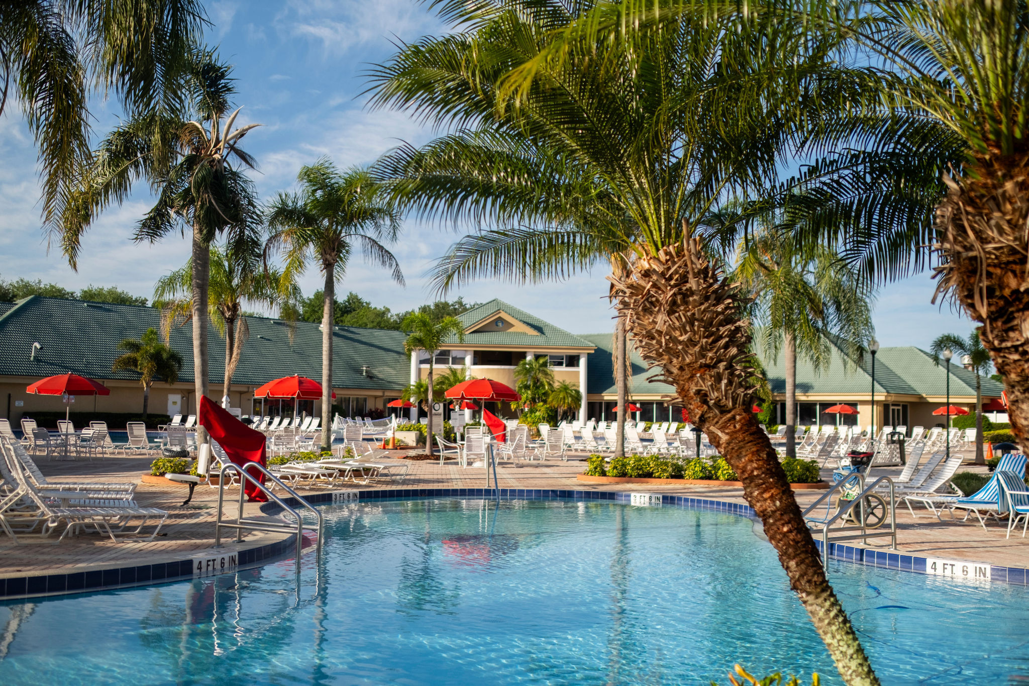 image Experience luxury at this sprawling resort pool, complete with comfortable seating and a scenic backdrop for your vacation paradise.