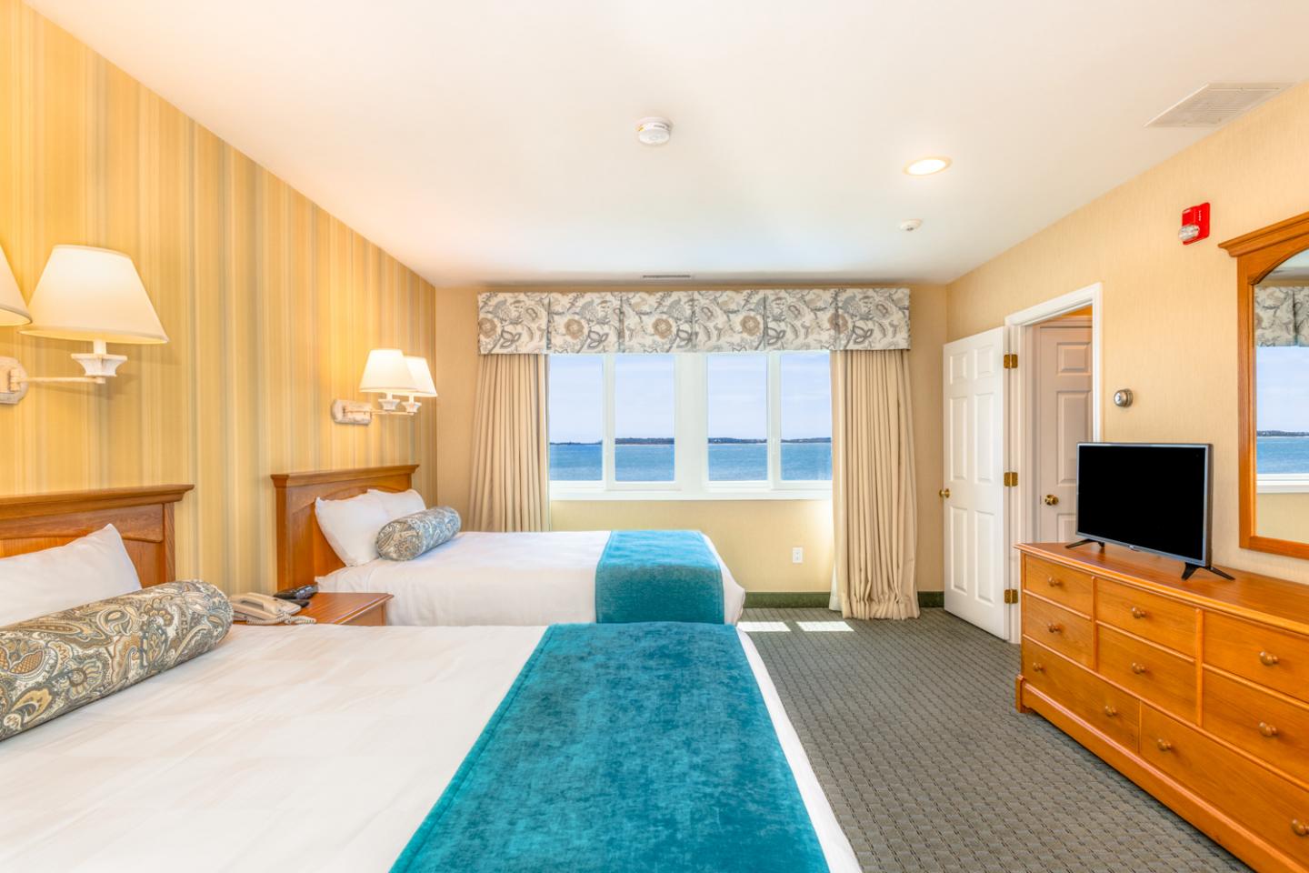image Sink into plush comfort after a day by the water, surrounded by soft tones and seaside serenity.