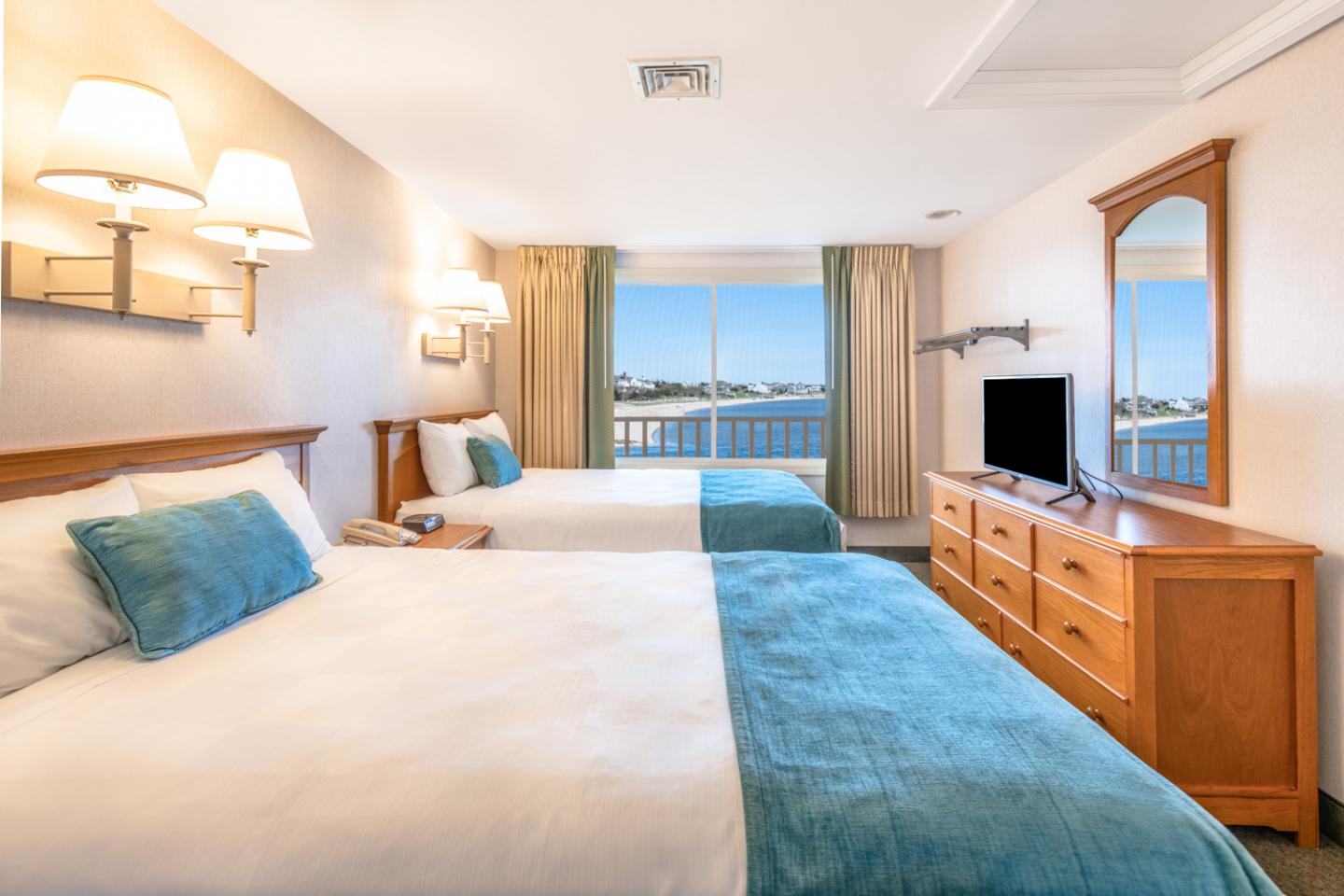 image Rest easy in a serene retreat where soft textures and water views set the tone for peaceful Cape Cod nights.