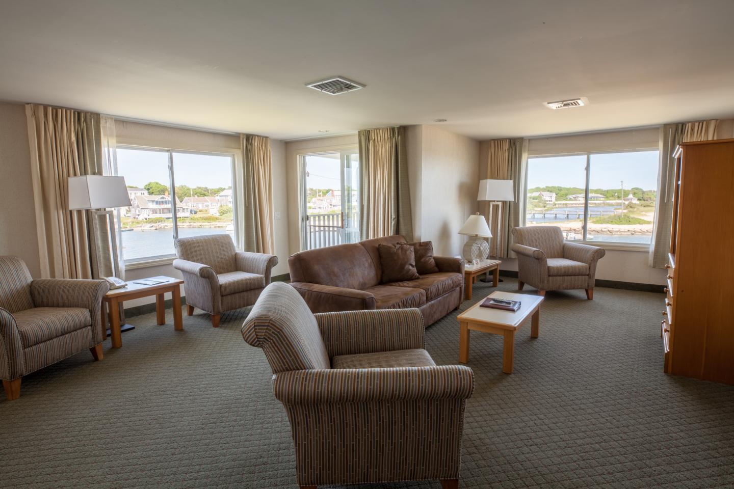 image Stretch out and relax in a light-filled space where windows frame peaceful harbor scenes from every angle.