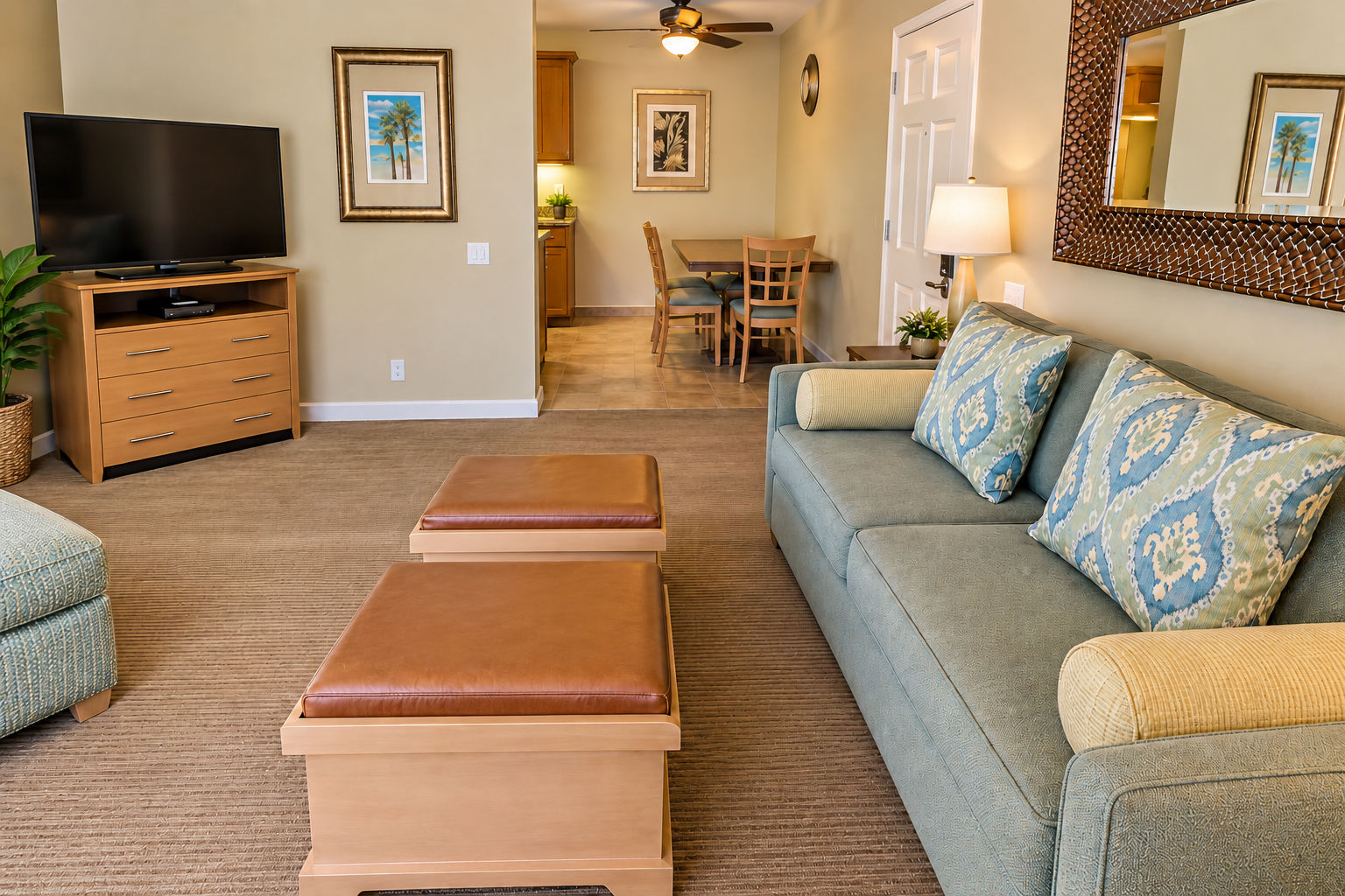 image Living area with a sofa, TV, and dining area