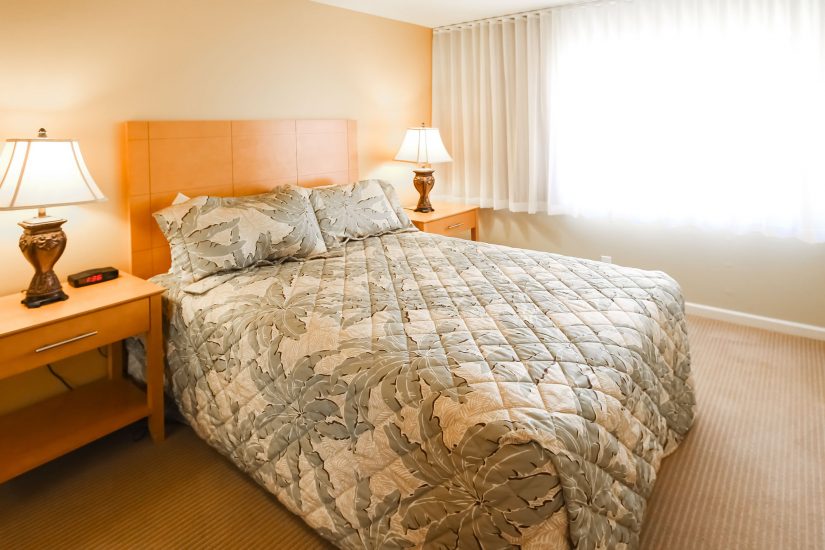 image Enjoy restful nights in this inviting bedroom featuring a comfortable king bed, stylish decor, and abundant natural light for a cozy desert retreat atmosphere.
