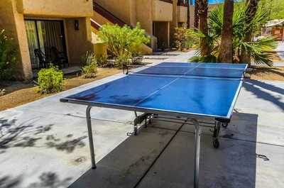 Play a round of ping pong at the outdoor table, surrounded by the serene desert landscaping of this relaxing resort.