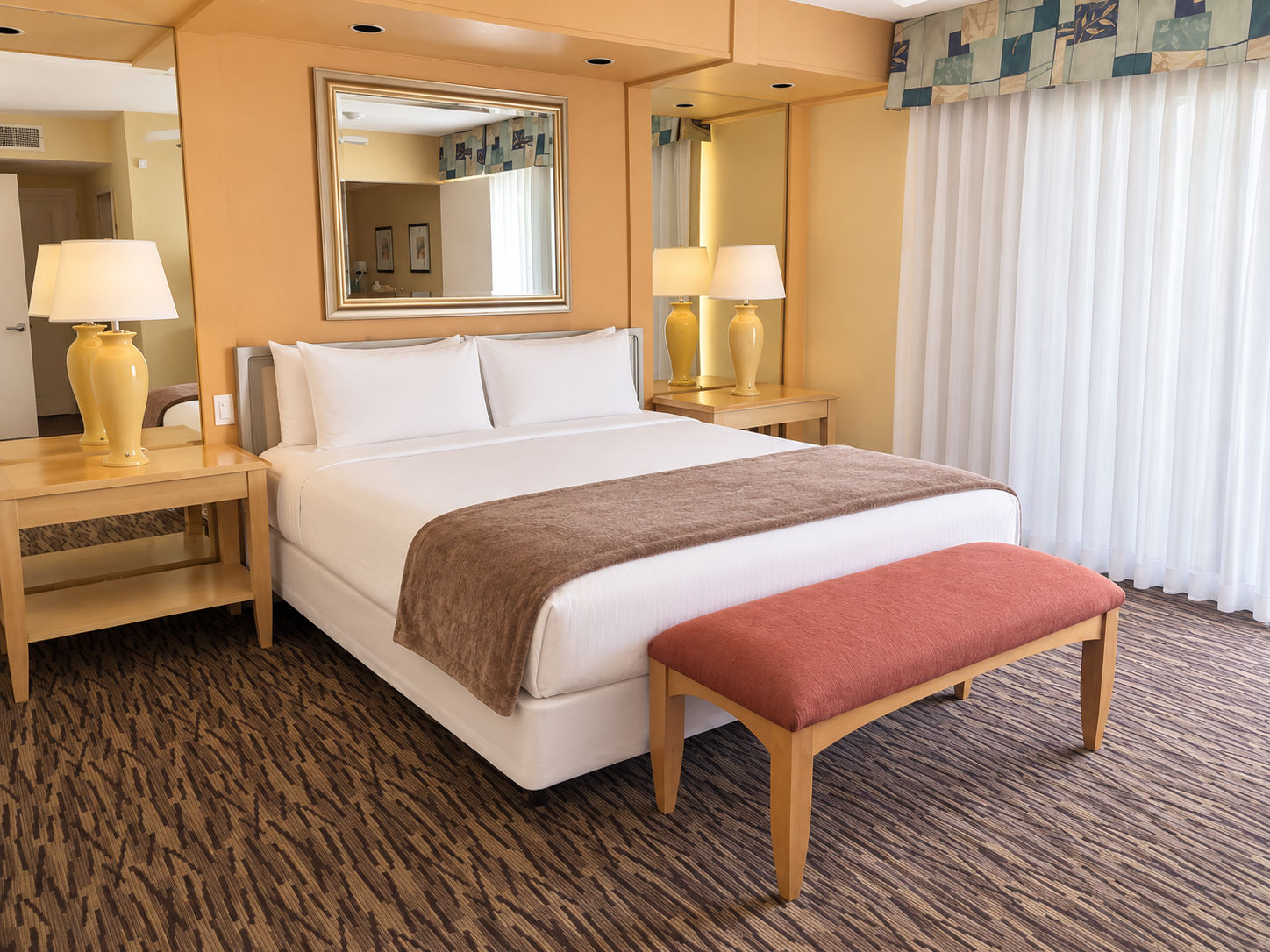 image Bedroom with one bed, a bench, lamps, and a mirror