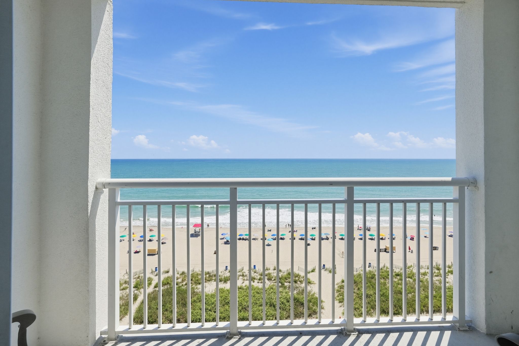 image Ocean view from balcony with beach umbrellas below