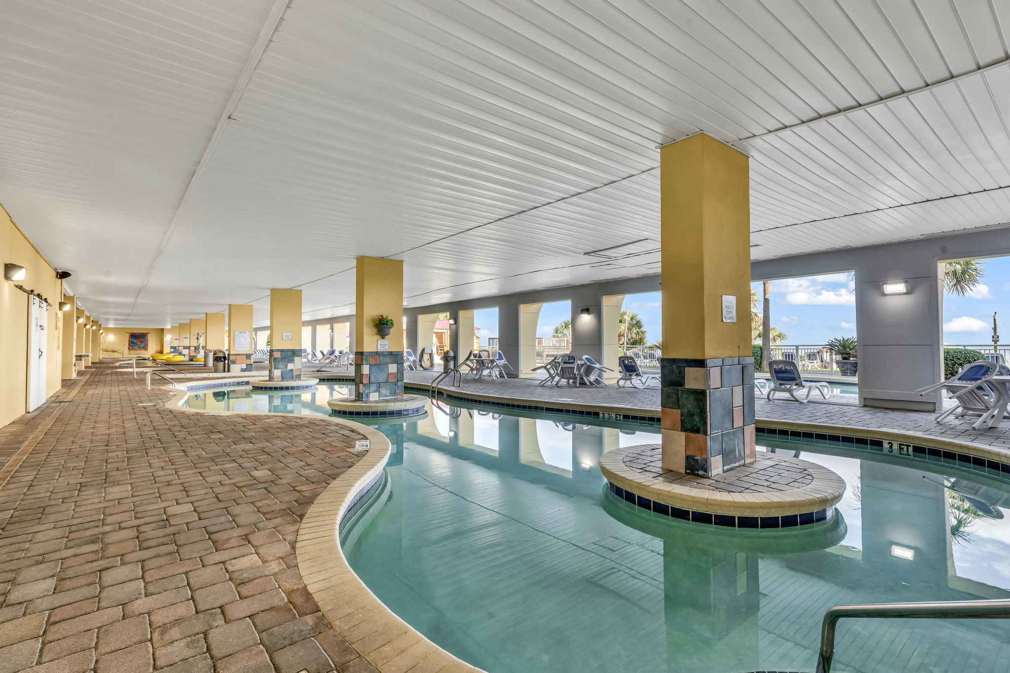 image Indoor lazy river with poolside lounge chairs