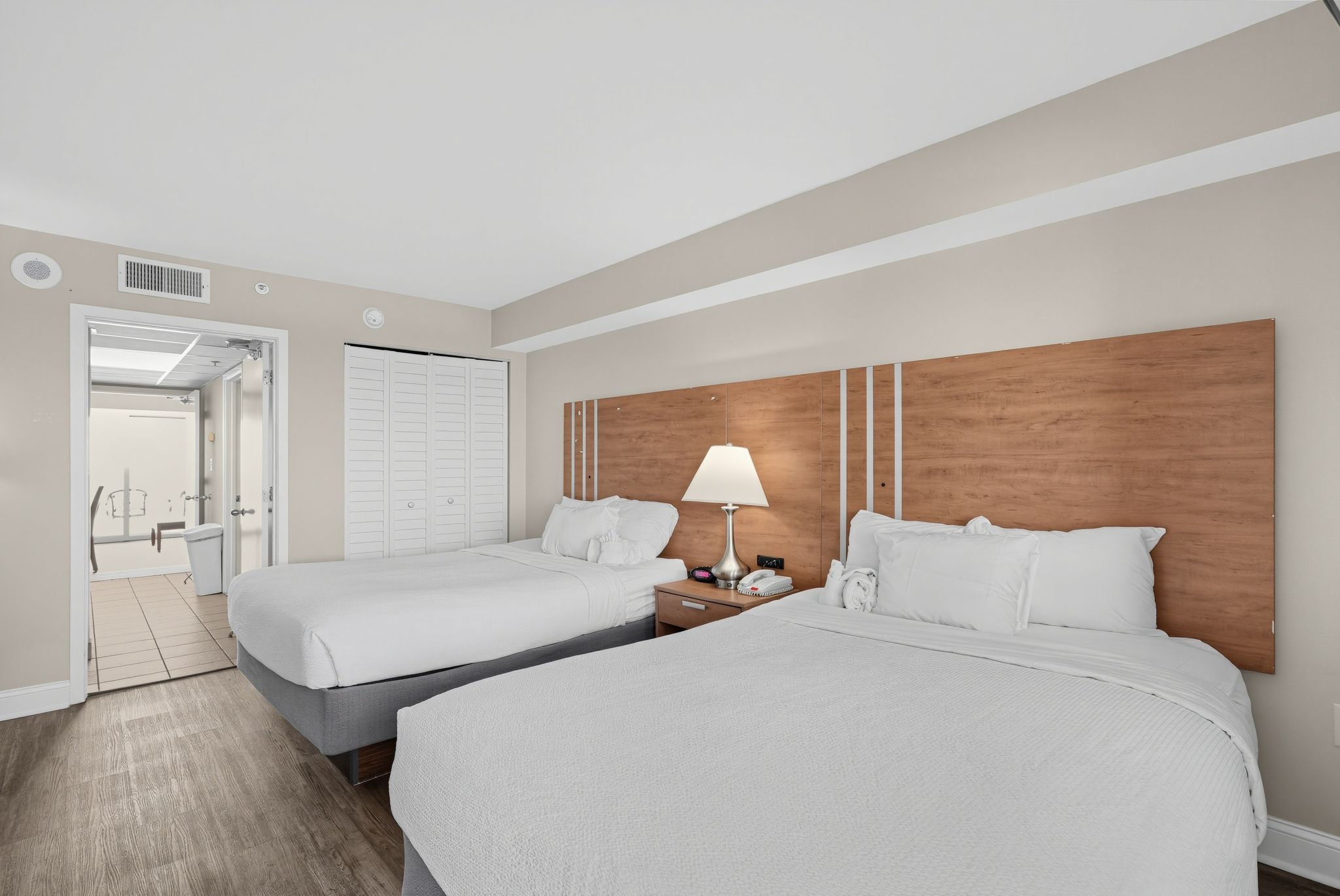 image Room with two beds, closet, and bathroom entrance