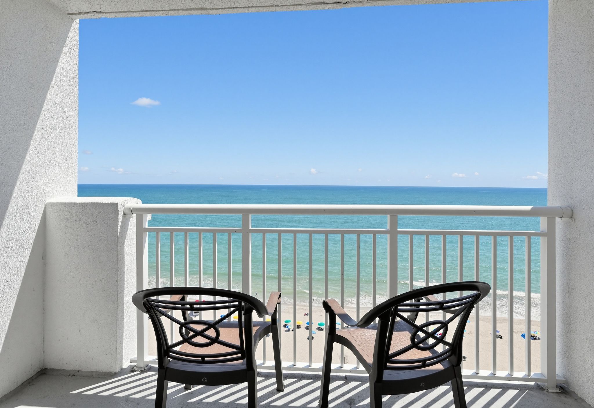 image Balcony with two chairs overlooking the beach and ocean